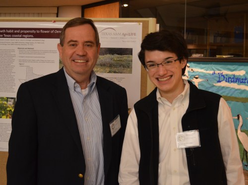 Dr. Jerry Cook and Commander Ben near invasive species posters